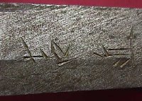 Two signature markings on side of tang